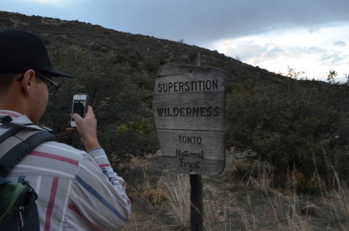 Jon, taking a photo of the Superstition Wilderness sign. We hiked in as the sun was setting.